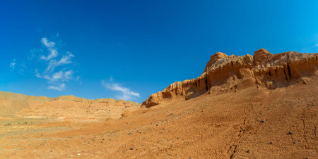 Panorama. Red Mountains of Boguty. From above, this desert canvas paints a mesmerizing picture with...