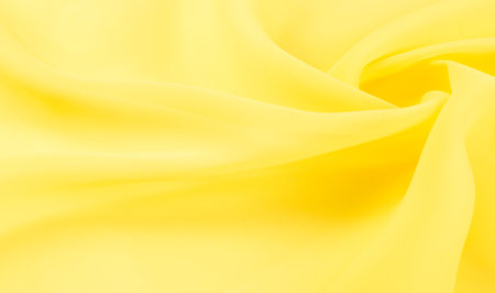 background seamless texture - yellow silk. Premium silk organza in pale yellow is an exceptional fabric, beautiful both on its own and as an accessory in terms of highlighting.の写真素材