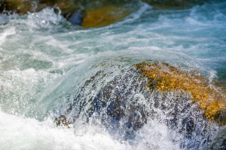 Feel the soothing sounds of a mountain stream. Immerse yourself in the enchanting melody of nature. Travel through lush green landscapes and be captivated by its beauty.の写真素材