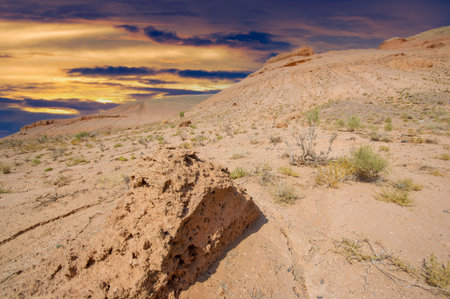 Enjoy the beauty of a desert sunset in the Red Boguta Mountains. Witness the golden glow of the sun illuminating the jagged peaks. Be enchanted by the breathtaking scenery of the Fire Wonders.の写真素材