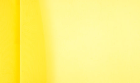 background seamless texture - yellow silk. Premium silk organza in pale yellow is an exceptional fabric, beautiful both on its own and as an accessory in terms of highlighting.の写真素材