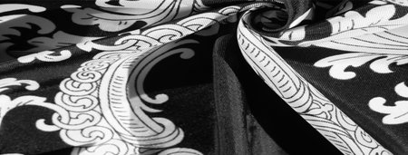 Black and white silk fabric with monogram. Exquisite filigree fabric pattern. texture, backgroundの写真素材