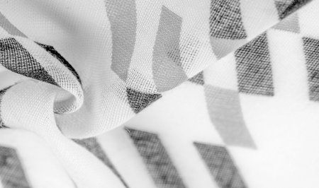White silk fabric with black geometric rhombus shapes. dark. Background. Template.