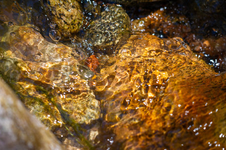Experience the mesmerizing dance of water and stones. Witness a harmonious fusion of grace and strength. A breathtaking display of natural elements in perfect balance.の写真素材