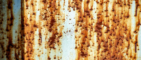 Rust on metal. Texture, background, pattern. When iron comes into contact with water and oxygen, it...