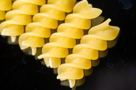 Delicious fusilli pasta made from high quality Italian wheat. Golden color and perfect texture for a hearty lunch. Enjoy the taste of Italy with every bite.の写真素材