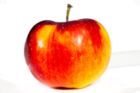 Enjoy a juicy apple for a boost of vitamin C. Sit back and relax with a bright, vibrant apple. Embrace the concept of health and wellness with this delicious fruit.の写真素材