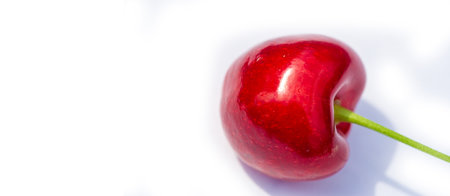 Fresh cherries with a juicy and ripe taste. Rich in vitamins and ideal for a vegetarian diet. Healthy snack option on a white background.の写真素材
