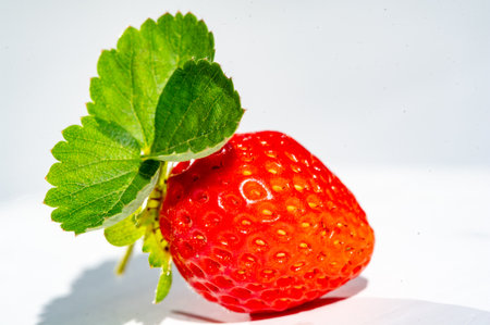Strawberries are an excellent source of vitamin C. Juicy and ripe strawberries make a delicious fruit juice. The white background really brings out the vibrant red color of the strawberries.の写真素材