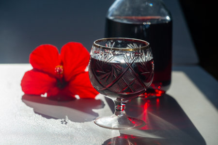 Enhance your dining experience with a crystal wine glass. Add a touch of luxury to your party with a bottle of red wine. Create an elegant atmosphere in your dining room with crystal accents.の写真素材
