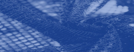 Blur, a detailed view of soft blue fabric with a decorative mesh texture, revealing intricate...