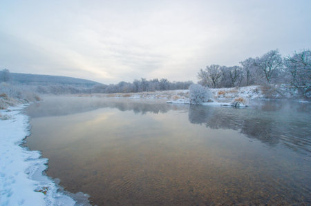 The frozen river reflects the golden light of the sunrise. A winter wonderland filled with serenity...