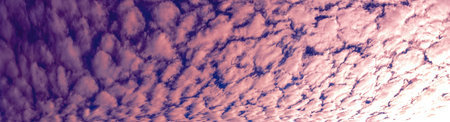 Broken dawn. Crimson clouds, strong red and pink streaks indicate tall clouds reflecting light at...