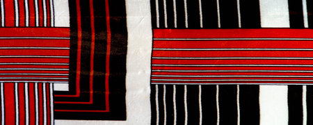 silk fabric with a red-brown pattern with white stripes. Poncho with Mexican motives. texture, backgroundの写真素材