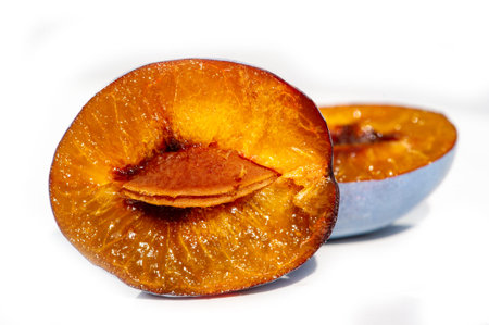 Sliced plum isolated on white background. Clipping path included.