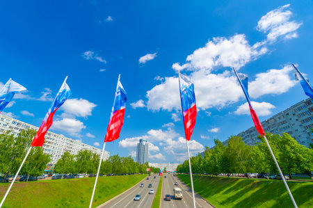 Flags representing different countries flutter against the backdrop of the city. It promotes cultural diversity and international relations. Flags add a lively and colorful element to the cityscape.の写真素材