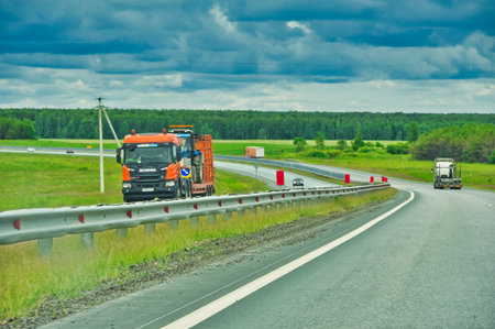 Enjoy a scenic drive through dense forests. Enjoy the beauty of nature without leaving your car. Admire the majestic trees lining the highway.の写真素材
