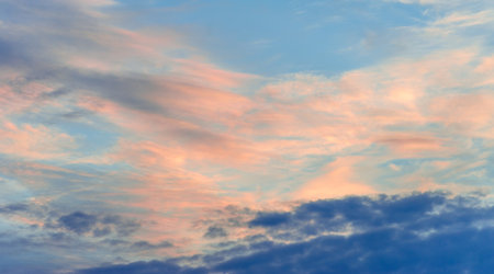 Broken dawn. "Crimson clouds", strong red and pink streaks indicate tall clouds reflecting light at sunrise or sunset.の写真素材