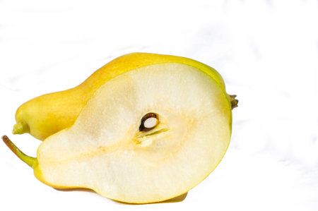Photo of a fresh pear on a white background for a neat look. A piece of juicy pear showing its vitamin content. Clipping path available for easy editing and customization.の写真素材