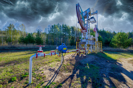 Pumpjack A unique and visually striking depiction of a pumping machine in thunderclouds. The combination of industrial and natural elements creates a sense of contrast and intrigue.の写真素材