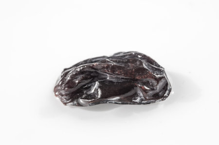 Minimalism at its best: one black raisin on a white canvas The power of simplicity in art Less is...