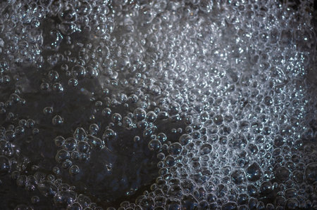 A fascinating dance of air bubbles on the water. Experience the pure liquid joy of a mountain river. Enjoy the soothing whispers of nature. Discover your own nirvana among the beauty of waterの写真素材