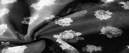 Elegant Black Fabric with Soft Floral Patterns, Suitable for Apparel and Home Decor Textilesの写真素材