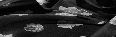 Beautiful Black Fabric with White Floral Pattern and Soft Drapes, Perfect for Upholstery and Fashion Designの写真素材
