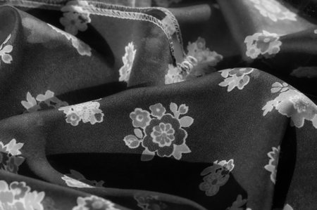 Elegant Black Fabric with White Floral Embellishments, Draped and Smooth, Ideal for Fashion or Interior Designの写真素材