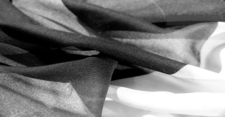 Experience the luxurious feel of exquisite silky fabric. Elegant black and white tones for timeless sophistication. The slightly wrinkled texture adds depth and dimension to any design.の写真素材