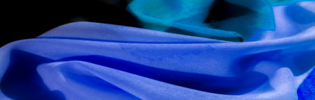The vibrant blue and black pattern creates a stunning visual impact. The unique pleating technique enhances depth and texture. Ideal for creating fashionable accents in clothing or accessories.の写真素材