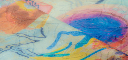 An artistic abstract fabric with soft folds, featuring a mix of vibrant blue, yellow, and red hues,...