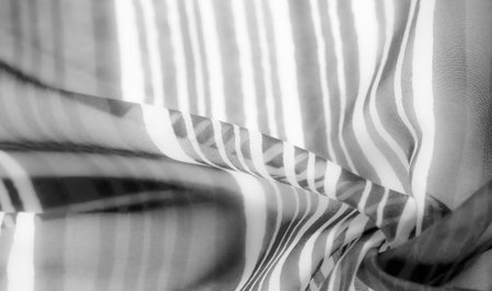 Grayscale fabric with delicate flowing stripes, creating a soft, ripping effect with gentle curves and a dynamic sense of movement.の写真素材