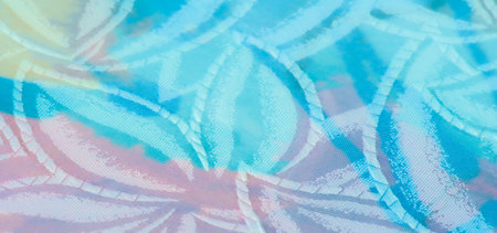 Photo Description: A pastel-colored, shimmering fabric with subtle floral patterns. The folds create...