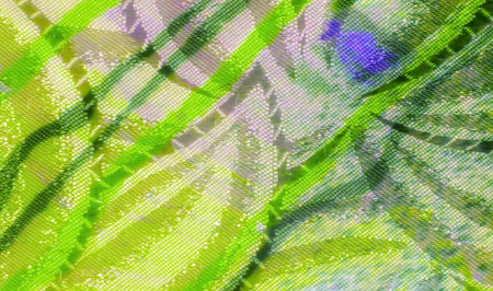 A vivid close-up of green, purple, and light blue abstract patterns on smooth fabric. The fabric shows intricate designs and soft textures with a mix of bright, neon colors.の写真素材