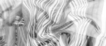 A gentle fabric with wavy grayscale lines, creating a fluid motion and elegant design across its soft, flowing surface.の写真素材
