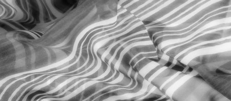 A grayscale fabric with fluid waves and gentle curves, creating a dynamic yet soothing visual effect, enhanced by its flowing nature.の写真素材