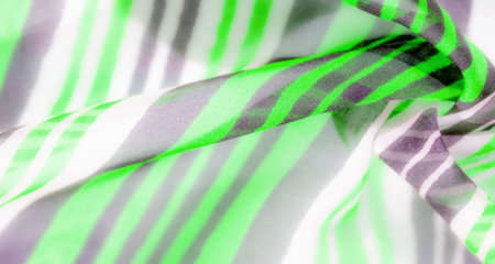 The series of images features vibrant green and gray horizontal stripes on lightweight fabric,...