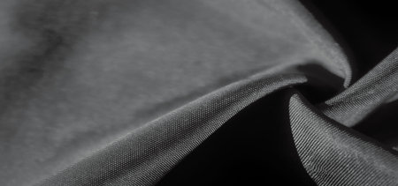 Soft folds of fabric are gently illuminated, creating an artistic interplay of light and shadow. The...
