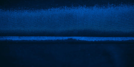 A blue textured background with uniform yet soft dots, providing a sense of depth and balance. The image features a fine, dotted texture, making it ideal for creative or corporate design projects.の写真素材