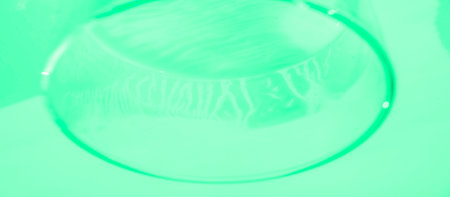 Blurred green fabric with soft folds and a smooth surface, creating a seamless and calming texture. The minimalist design is perfect for abstract art projects or subtle creative backdrops.の写真素材