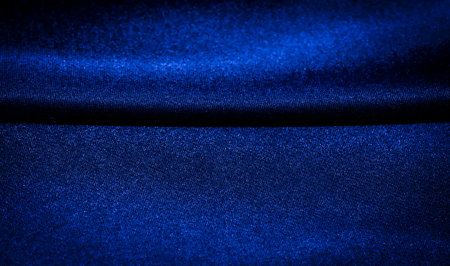 Blurred texture of deep blue fabric with soft weave The blur effect enhances the soft weave and texture of the deep blue fabric. The complex textile pattern is presented in a gradient of shadesの写真素材