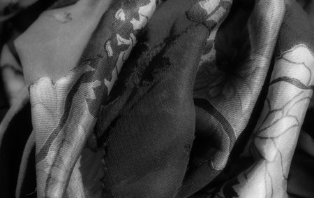 Blur the grayscale floral patterns unfold over the dark fabric, creating a smooth blend of shadows and light, which enhances its natural elegance and sophisticated appearance.の写真素材