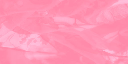 Blurred soft pink floral fabric featuring intricate patterns and delicate texture. The gentle curves and folds of the material create an ethereal and dream-like appearance.の写真素材