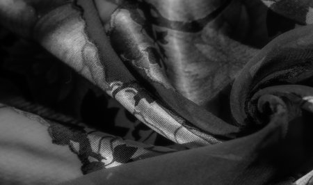 Blur of a soft floral fabric with abstract floral motifs. The gentle fabric texture offers a beautiful play of light and shadow, enhancing the elegance and complexity of the textile design.の写真素材