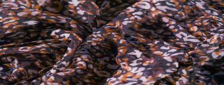 Blur of intricate red, black, and white abstract motifs on a smooth, sheer fabric. The layered...