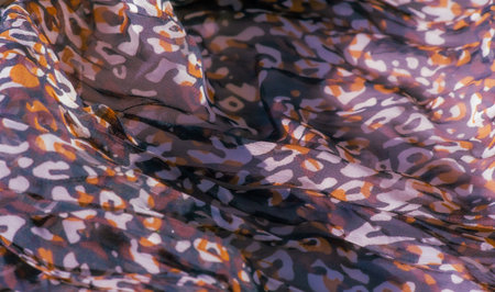 Blurred artistic close-up of flowing fabric in red, black, and white, featuring abstract leopard-like prints The soft, layered texture adds dimension, making it a stunning choice for artistic projectsの写真素材