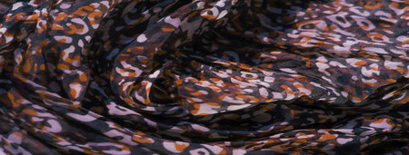 Blur of soft fabric with intricate red, black, and white abstract patterns. The design appears...