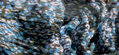We blur the abstract fabric pattern with a mixture of green, blue and white on a black base. The texture of the fabric is soft and the uneven shapes create a camouflage pattern.の写真素材