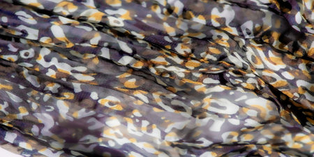 Blur Abstract fabric design features intricate purple, yellow and brown patterns that flow into a...
